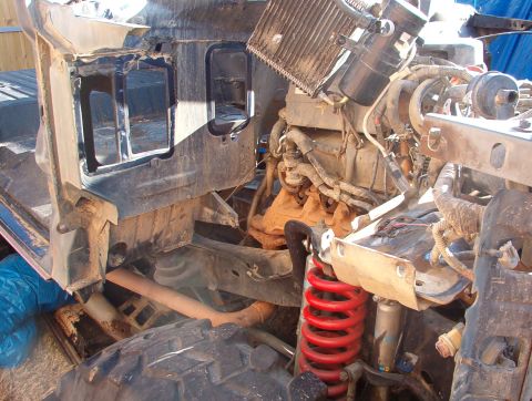 1994 Ford Bronco - Front end of a 1994 Ford Bronco disassembled, showing engine and chassis components.
