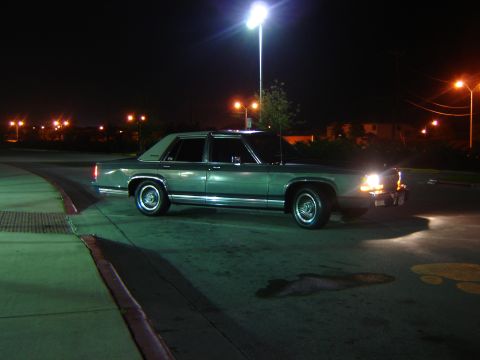 1988 Ford Crown Victoria LTD - Side view of a 1988 Ford Crown Victoria LTD at night.