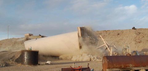 1979 Ford Bronco - A large cylindrical object is falling in a dusty desert landscape, with construction equipment visible.
