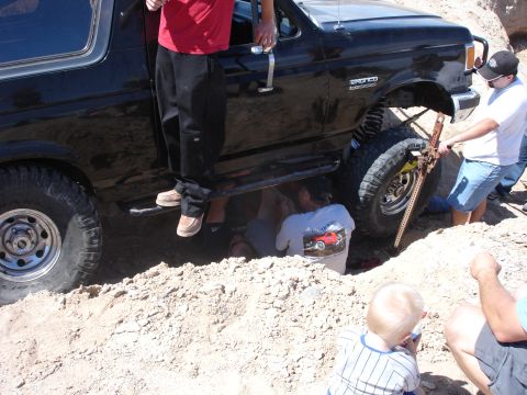 1996 Ford Bronco - Off-road enthusiasts work to free a stuck 1996 Ford Bronco using a Hi-Lift jack.