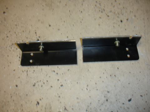 1996 Ford Bronco - Two black metal brackets are shown against a concrete background.