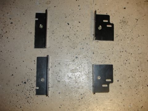 1996 Ford Bronco - Four black metal brackets are laid out on a concrete surface, with a Supermotors.net watermark at the bottom right.