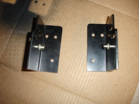 1996 Ford Bronco - These metal brackets appear to be new parts, possibly for a vehicle repair or modification.