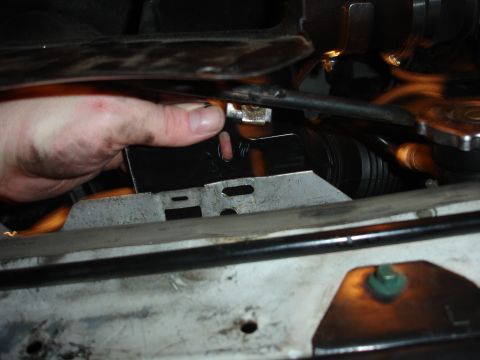 1996 Ford Bronco - A hand is shown installing a part near the engine fan, with visible text from Supermotors.net.