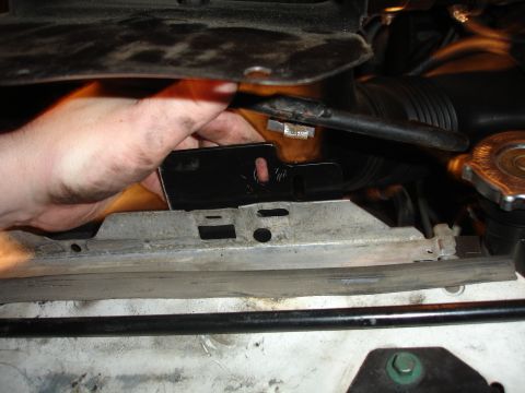 1996 Ford Bronco - Working on engine components, possibly related to cooling or air intake system.