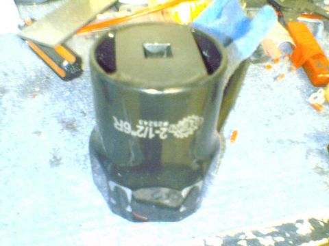 1996 Ford Bronco - A large socket wrench part is shown on a workbench with other tools.