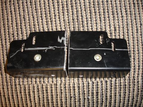 1996 Ford Bronco - Two black metal brackets are shown on a striped fabric background.