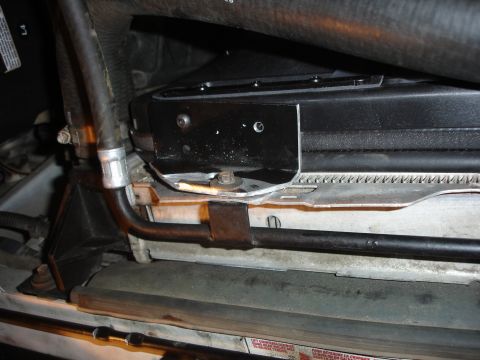 1996 Ford Bronco - Close-up view of a radiator fan shroud with hoses connected.