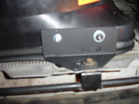 1996 Ford Bronco - A close-up view of a fan shroud bracket, showing its attachment points and the surrounding engine bay components.