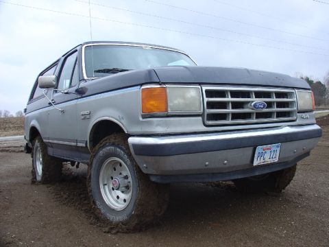 1988 Ford Bronco - 1988 Ford Bronco stuck in mud, showing front 3/4 view with license plate PPC 121.