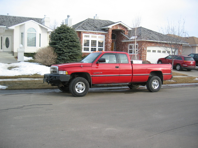 Red 1996 Dodge 2500 pickup truck, side view