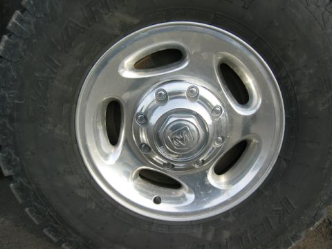 1996 Dodge 2500 - Close-up of a chrome Dodge Ram wheel with a Ram logo center cap and a Goodyear Wrangler tire.