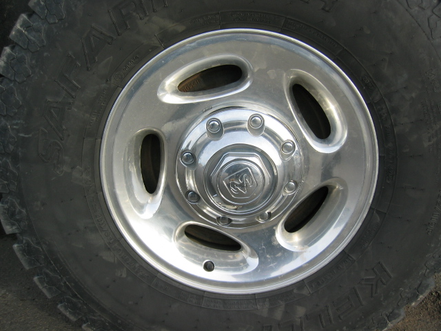 Close-up of a chrome Dodge Ram wheel with a Ram logo center cap and a Goodyear Wrangler tire