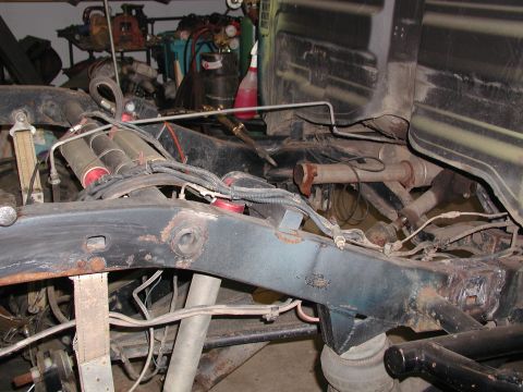 1989 Toyota Tacoma - Undercarriage view of a truck frame with suspension and exhaust components visible.