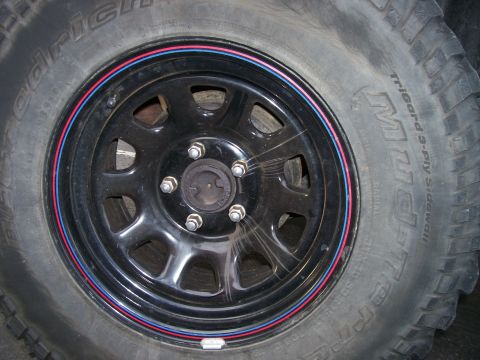1998 Jeep TJ - Close-up of a vehicle's wheel and tire, showing tire brand and wheel details.
