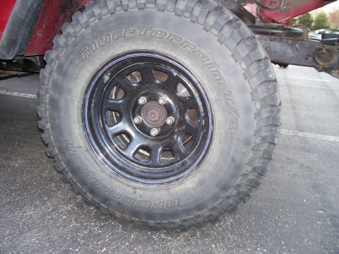 1998 Jeep TJ - Close-up of a BFGoodrich Mud-Terrain T/A tire and black wheel on a Jeep.