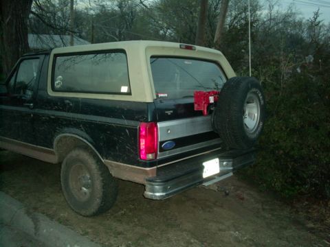 1994 Ford Bronco - This 1994 Ford Bronco features a rear-mounted spare tire and a two-tone paint scheme.