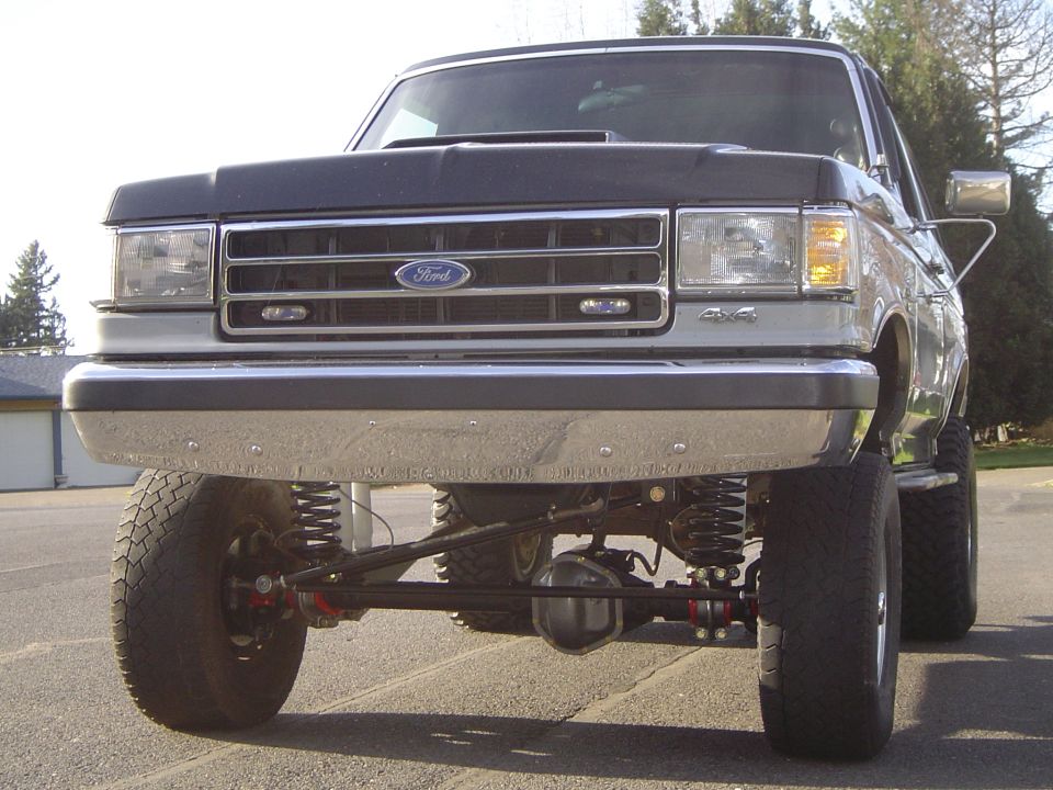 Front view of a lifted Ford 4x4 showing solid front axle and coil suspension