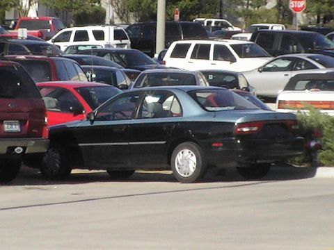 1994 Ford Probe - Side view of a 1994 Ford Probe sedan in a parking lot.
