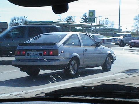 1994 Ford Probe - This silver coupe, likely from the 1980s, is seen from the rear with its distinctive spoiler and pop-up headlights.
