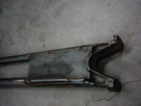 1978 Ford Bronco - A close-up view of a vehicle's radius arm, a component of the suspension system.