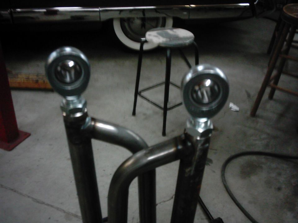 Close-up of two custom suspension rod ends with metal tubing