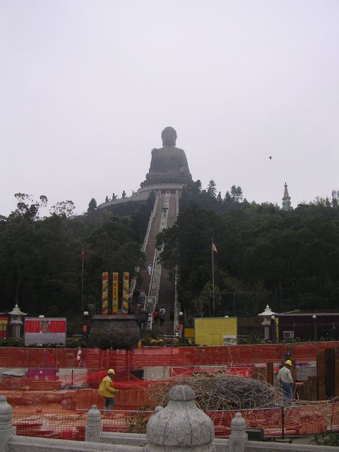 1999 Toyota Tacoma - A construction site is visible in the foreground, with the Tian Tan Buddha statue looming on a hill behind it.