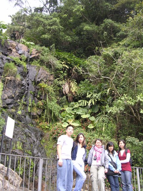 1999 Toyota Tacoma - A group of five people pose for a photo in front of a scenic waterfall and dense forest.