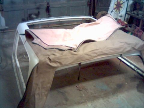 1986 Ford Bronco - The frame for a soft top is shown, covered with fabric, in what appears to be a workshop or garage.