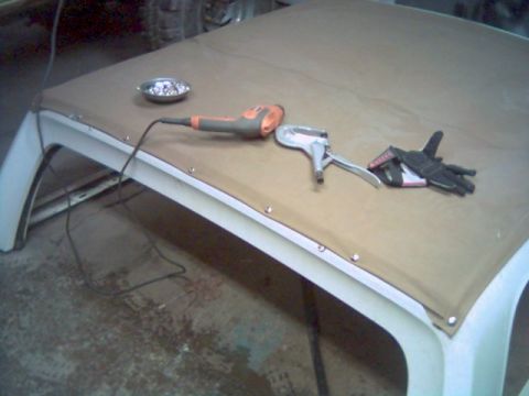 1986 Ford Bronco - Tools and gloves are laid out on a soft top, suggesting repair or installation work.