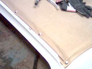 1986 Ford Bronco - Tools and gloves laid out on a soft top, possibly for installation or repair.