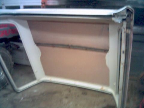 1986 Ford Bronco - The interior of a removable soft top is shown, tan lining and white trim.