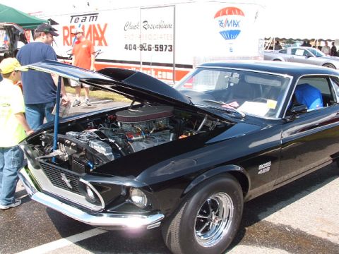 1966 Ford Ranchero - A black 1969 Ford Mustang Boss 429 is displayed with its hood open, revealing the engine compartment.