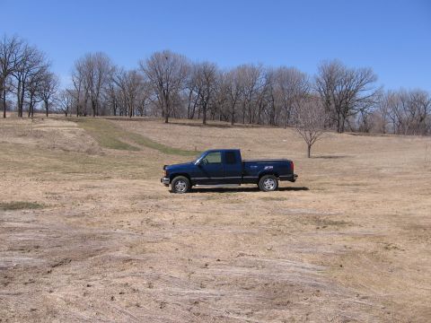 1995 GMC Sierra 1500 - A 1995 GMC Sierra 1500 pickup truck sits in a dry, grassy field under a clear blue sky.