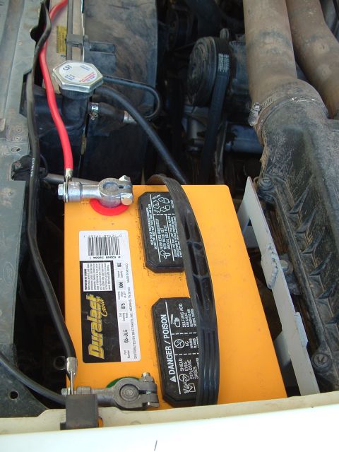 1990 Ford Bronco - Dual Duralast Gold batteries are visible in the engine bay, connected by red cables.
