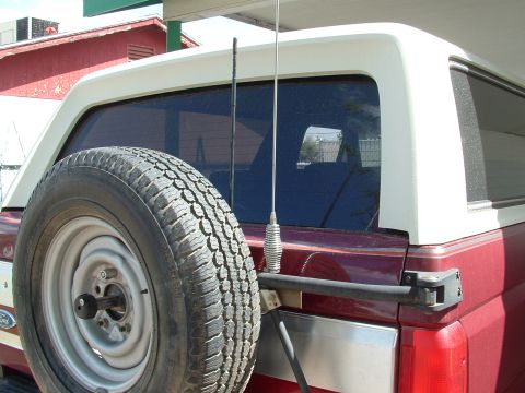 1990 Ford Bronco - Rear view of a 1990 Ford Bronco, complete with a spare tire and CB antenna mounted on the tailgate.