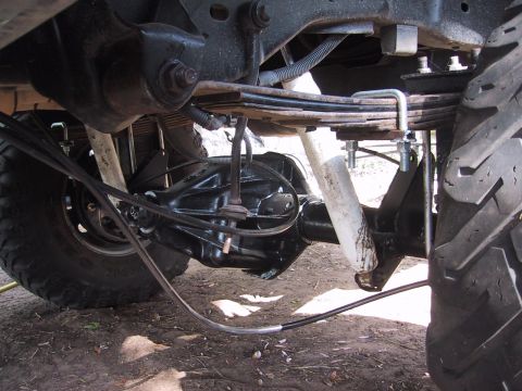 1990 Ford Bronco - The rear suspension and axle assembly of a vehicle are shown in detail.