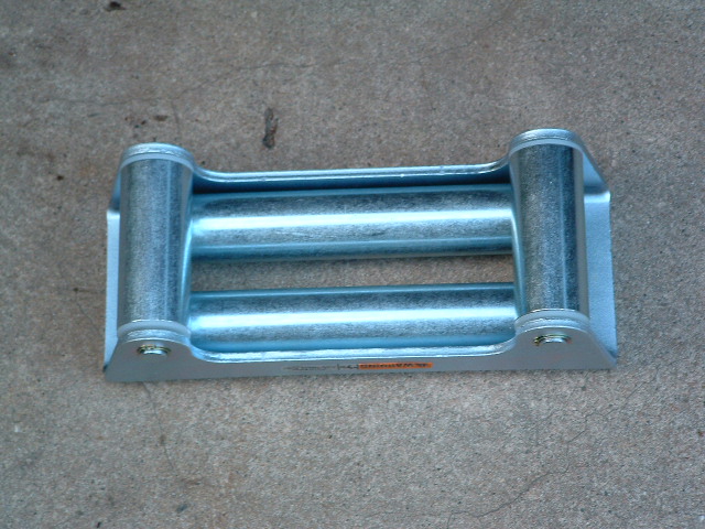 Metal winch roller fairlead with two horizontal rollers, mounted on concrete