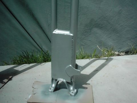 1978 Ford Bronco - A painted metal suspension component is shown, with a green tarp and grass in the background.