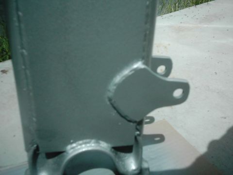 1978 Ford Bronco - A close-up view of a painted metal suspension component, likely part of a vehicle's chassis.