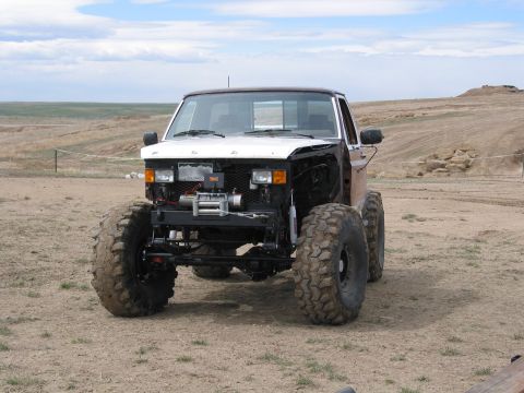 1981 Ford Bronco - This heavily modified truck features oversized tires and a front-mounted winch, suggesting off-road use.