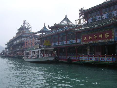 1999 Toyota Tacoma - A view of several large floating restaurants and boats docked along the waterfront.