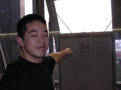 1999 Toyota Tacoma - A man gestures towards a sign that reads "Lai King" in both Chinese and English.
