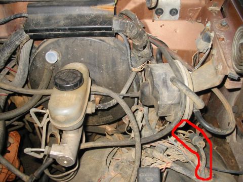 1988 Ford Bronco - Close-up view of the brake booster and master cylinder in an engine bay.