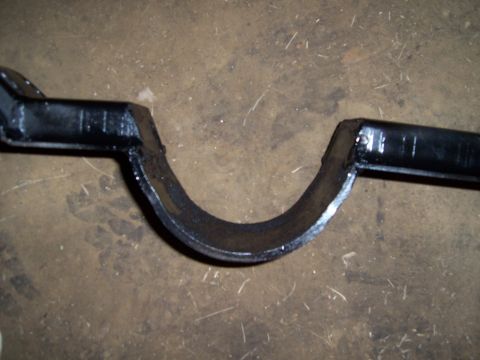 1983 Ford Bronco - A black metal automotive part is shown close-up against a textured floor.