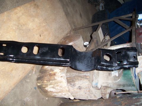 1983 Ford Bronco - Automotive part, possibly a frame component, shown in a workshop setting.