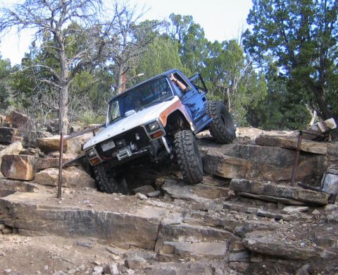 1981 Ford Bronco - An off-road SUV navigates a rocky terrain, demonstrating its climbing capabilities.