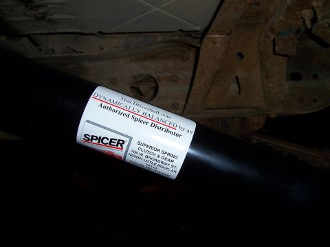 1983 Ford Bronco - A driveshaft is shown with a label from Spicer, a distributor of superior spring, clutch, and gear components.