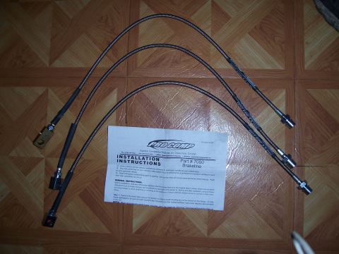1983 Ford Bronco - Pro Comp stainless steel brakelines and installation instructions are laid out on a tiled surface.