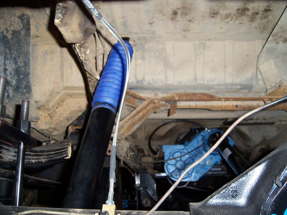 Undercarriage view of a blue shock absorber boot and a blue component